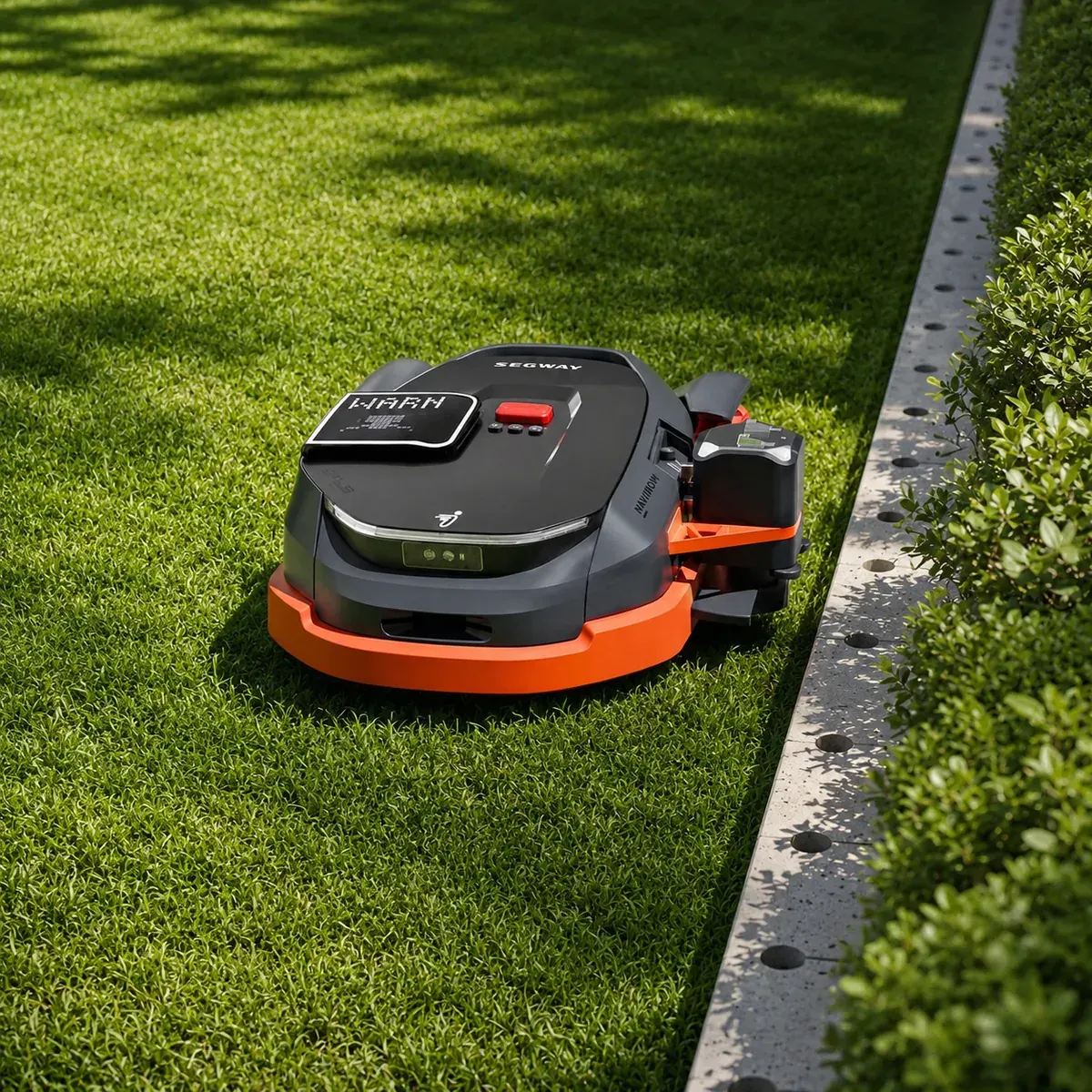 Segway Navimow robotfűnyíró sövény mellett a gyepen — telepítés utáni működés